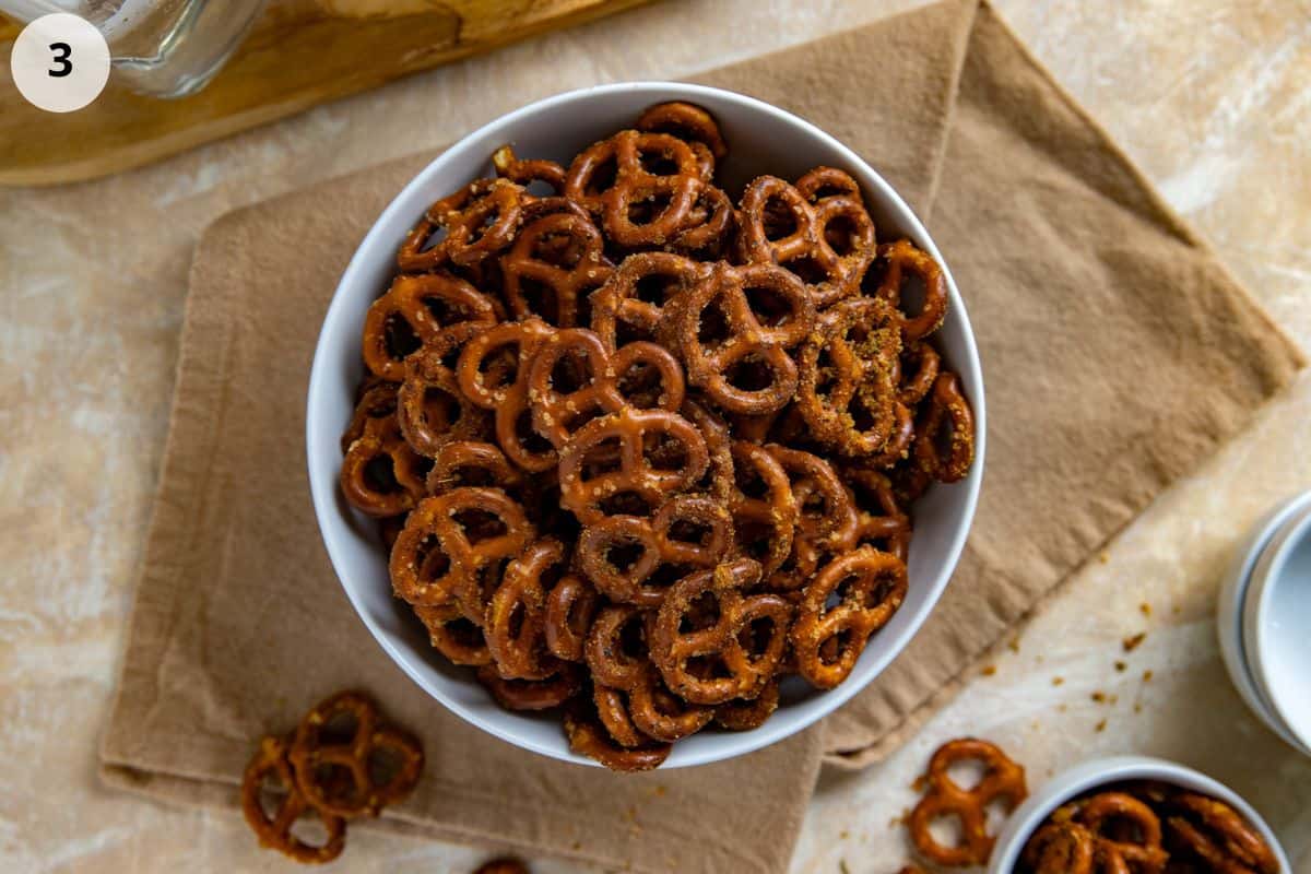 Seasoned pretzels and a white serving bowl.