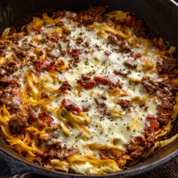 Baked casserole in a cast iron skillet.