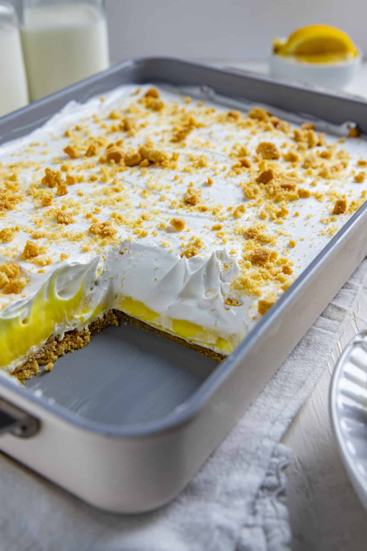A 9 by 13-inch pan of Lemon Lush with one serving removed.