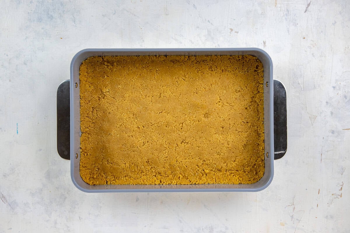 Cookie mixture pressed into the bottom of a 9x13-inch baking pan.