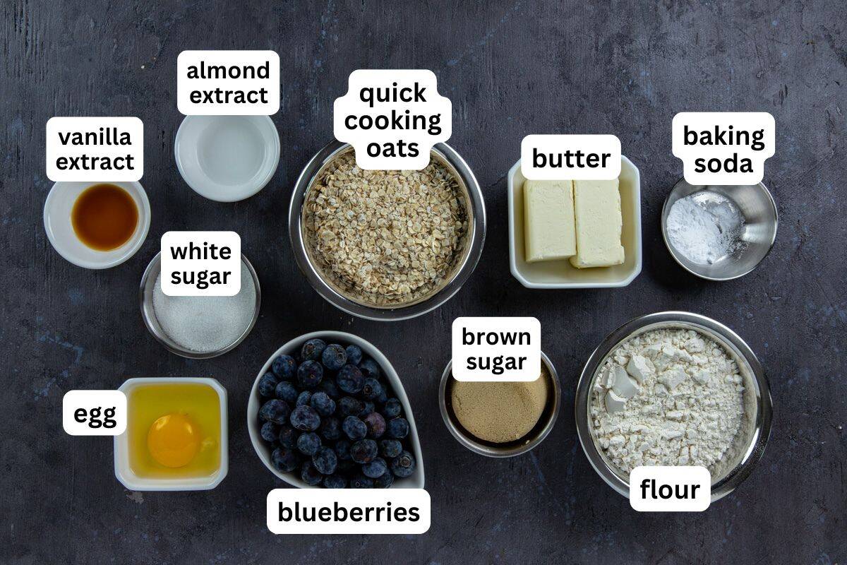 Ingredients measured out into separate containers on dark brown wooden countertop.