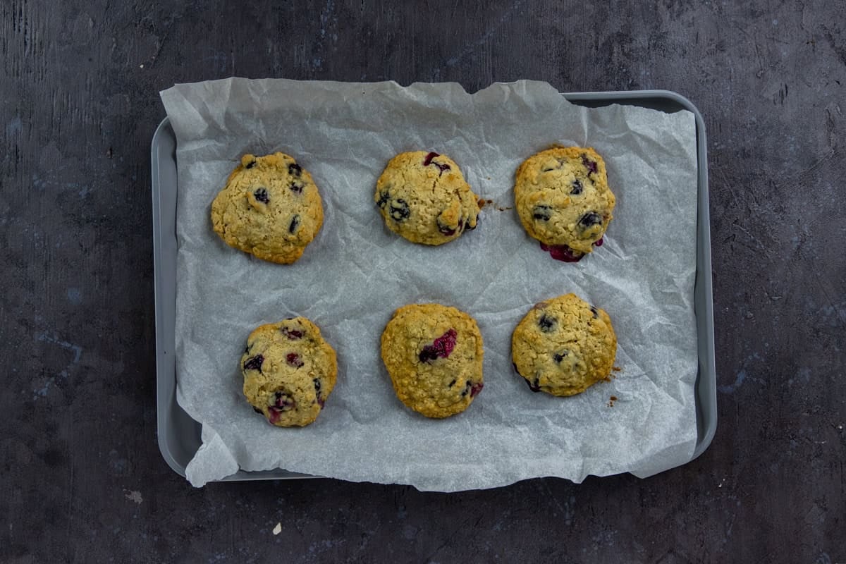 Baked cookies on parchment paper-lined cookie sheet.