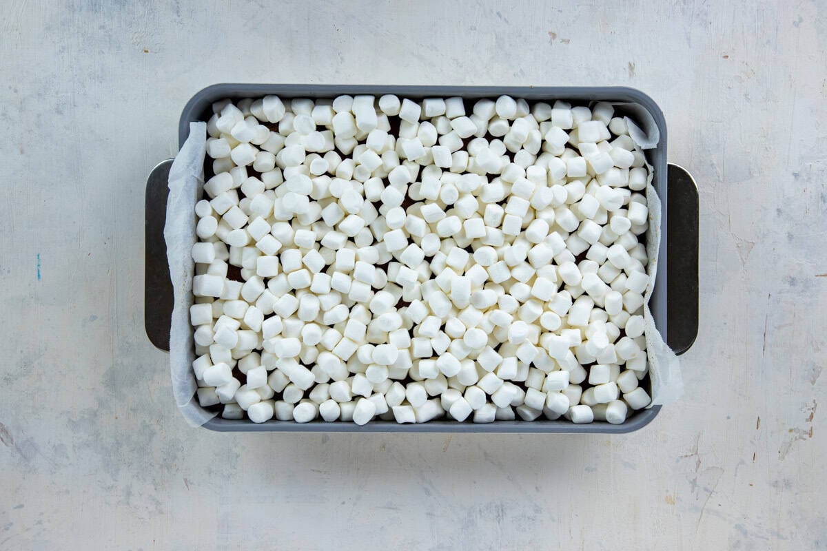 Hot cake in the cake pan topped with mini marshmallows.