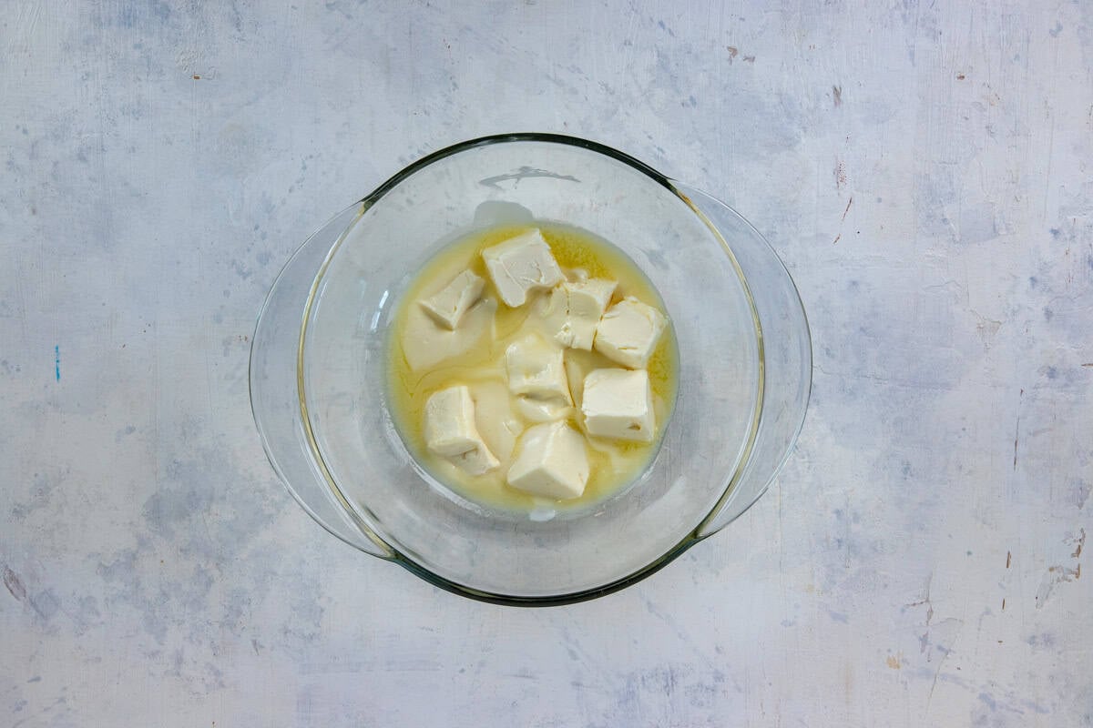 Softened butter in a glass mixing bowl.