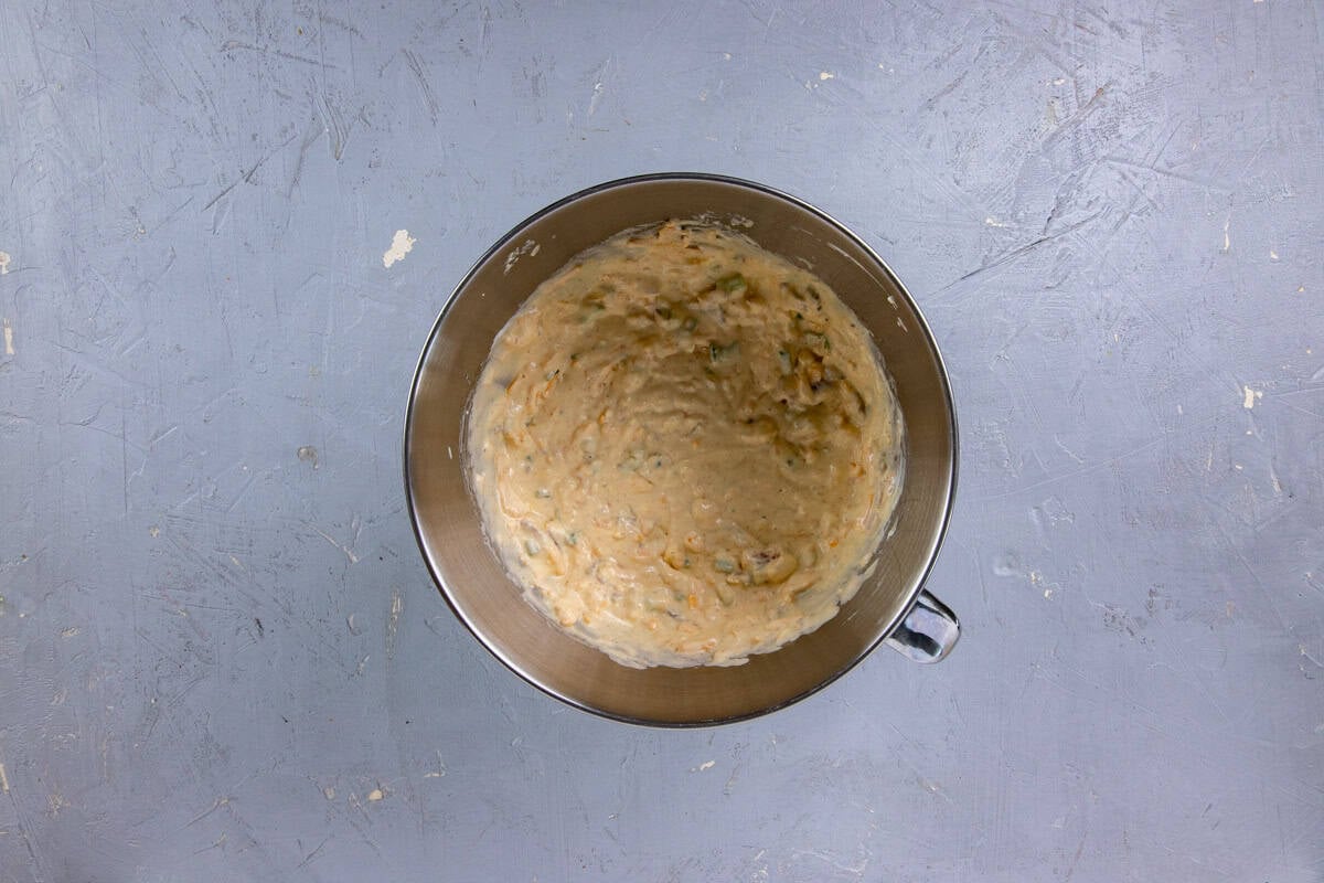 Cream cheese, sour cream, shredded cheese, bacon, butter, broth, salt, smoked paprika, garlic powder, black pepper, and green onions in a mixing bowl.