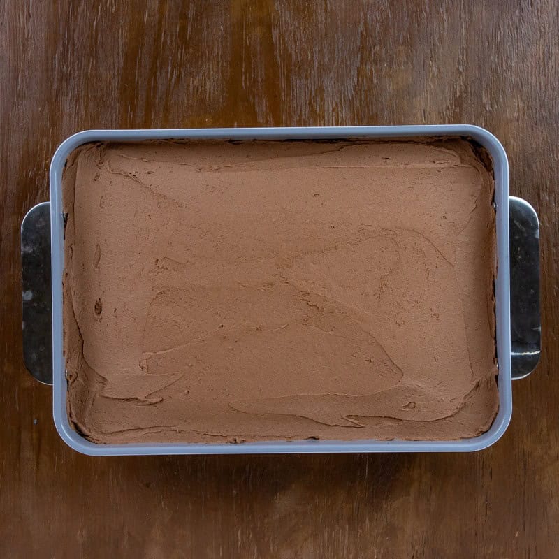 Baked and frosted cake in a 9 by 13-inch baking pan.