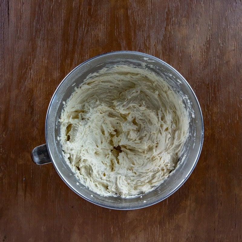 Milk added to the egg and butter mixture in the mixing bowl.