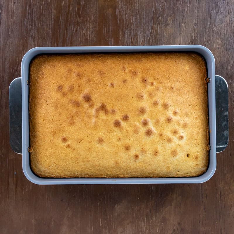 Baked cake in a 9 by 13-inch baking pan.
