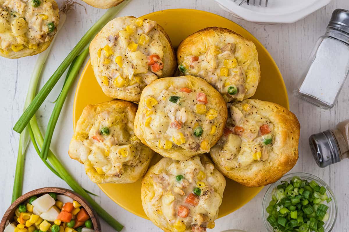 Overview of 6 baked chicken pot pies on a yellow round plate.