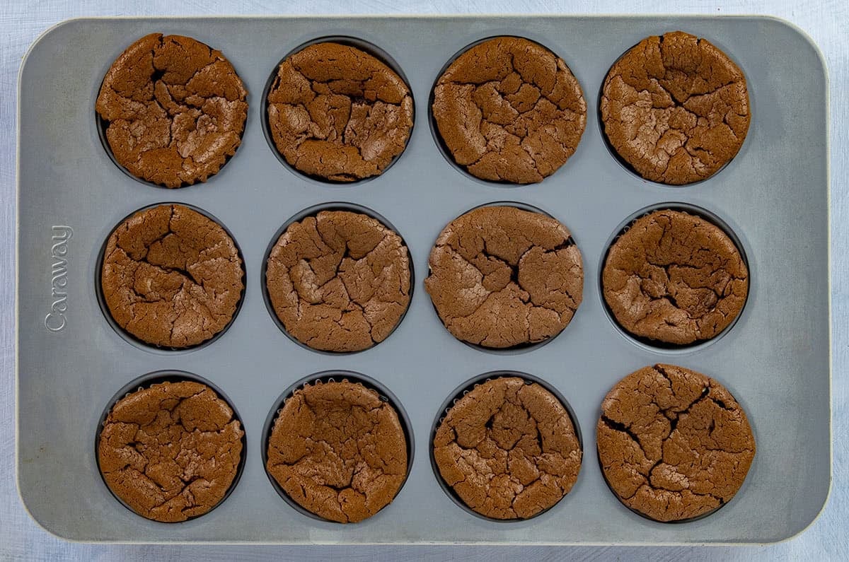 Twelved baked cheesecake cups still in the muffin pan.