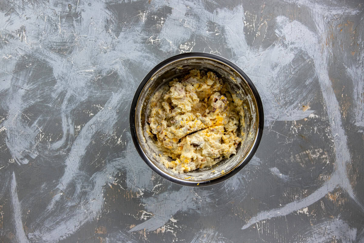 Cooked and crumbled bacon and shredded cheddar cheese folded into the mashed potato mixture.