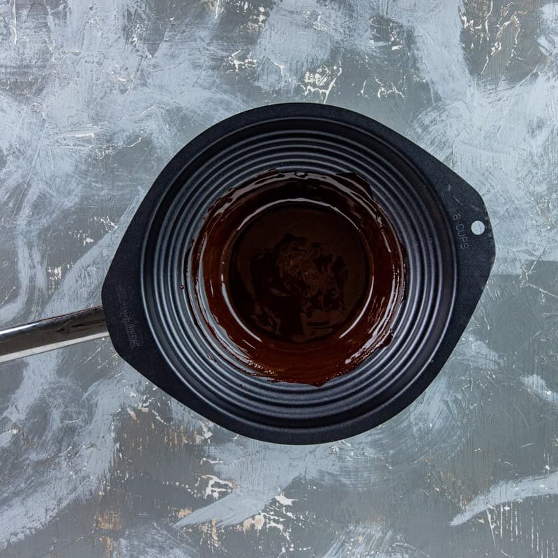 Melted chocolate and butter in a bowl over a sauce pan.