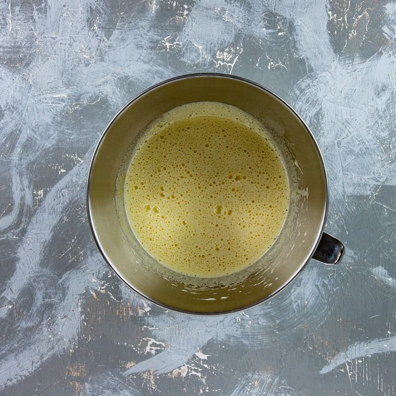 Eggs, sugar, and vanilla in a mixing bowl.