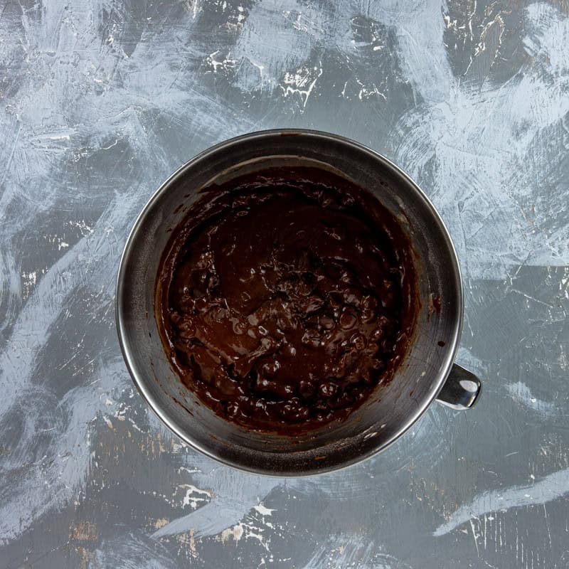 Melted chocolate-butter mixture mixed into the cocoa mixture. Chocolate chips stirred in.