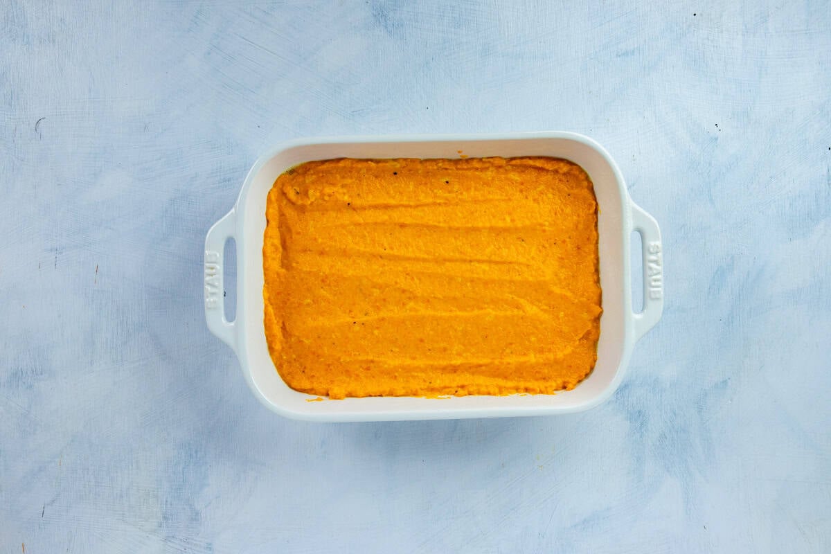 Carrot puree mixture in a white casserole dish.