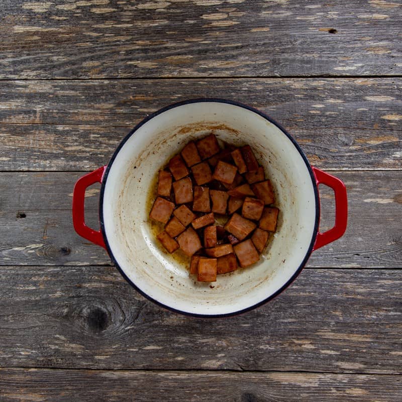 Browned sliced ham in a dutch oven.