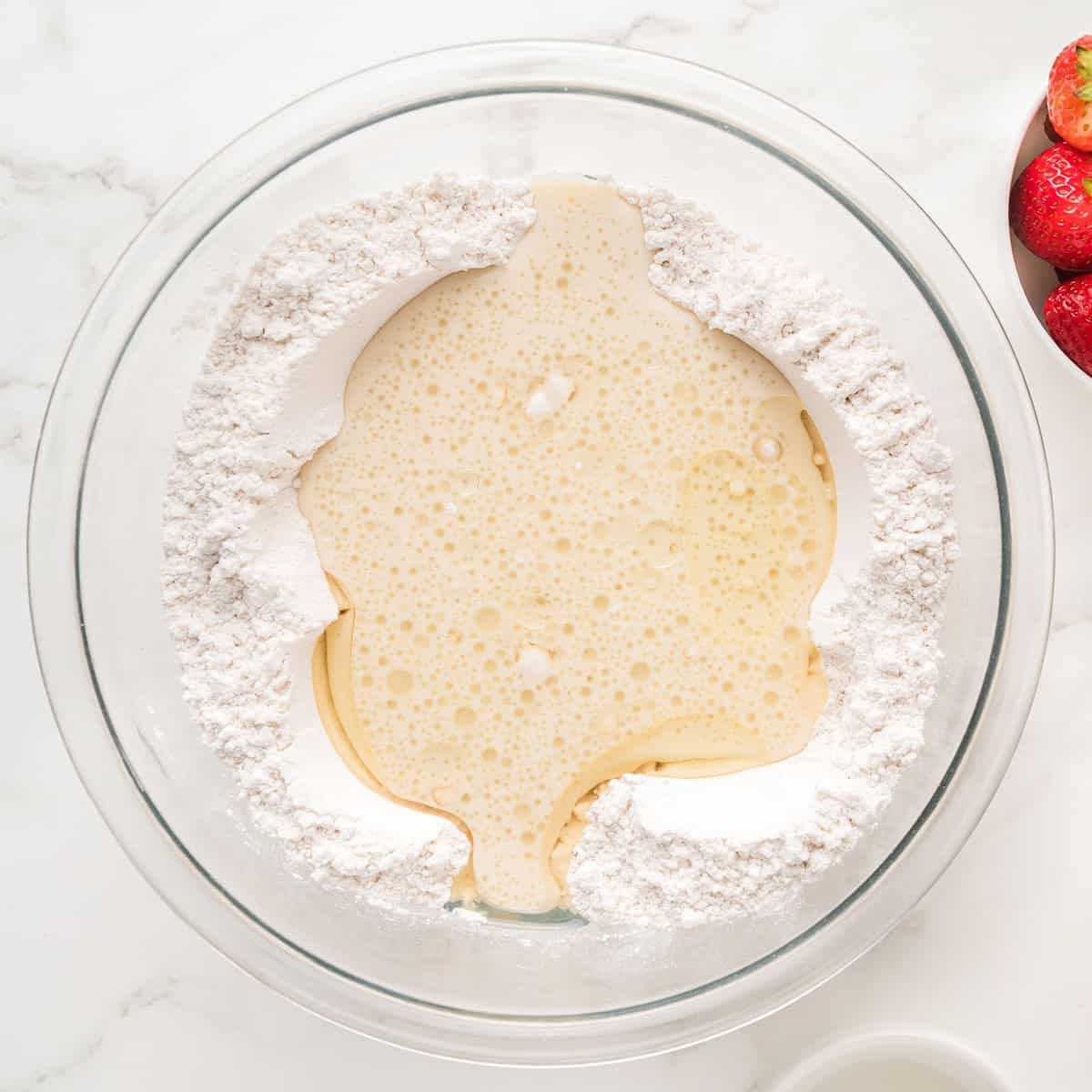 Oil and eggs in the bowl with the flour mixture.