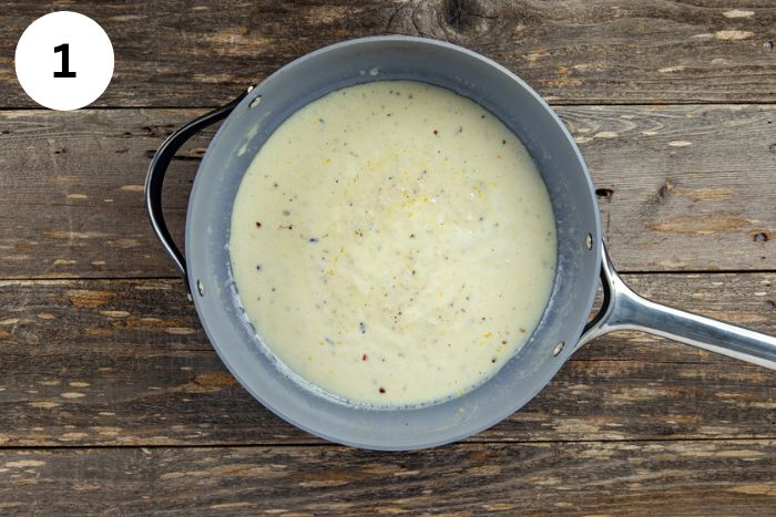 Alfredo sauce cooked in a skillet.