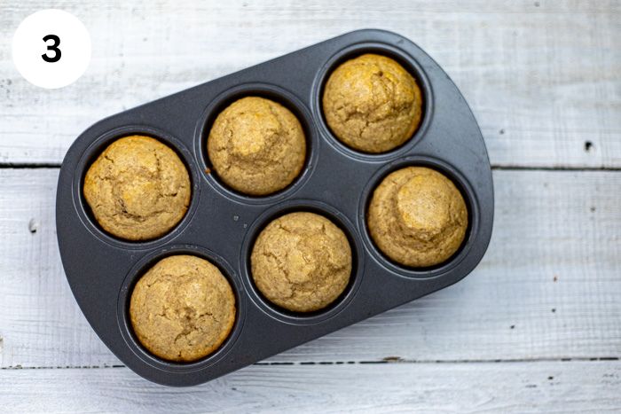 Six baked muffins in the muffin pan.
