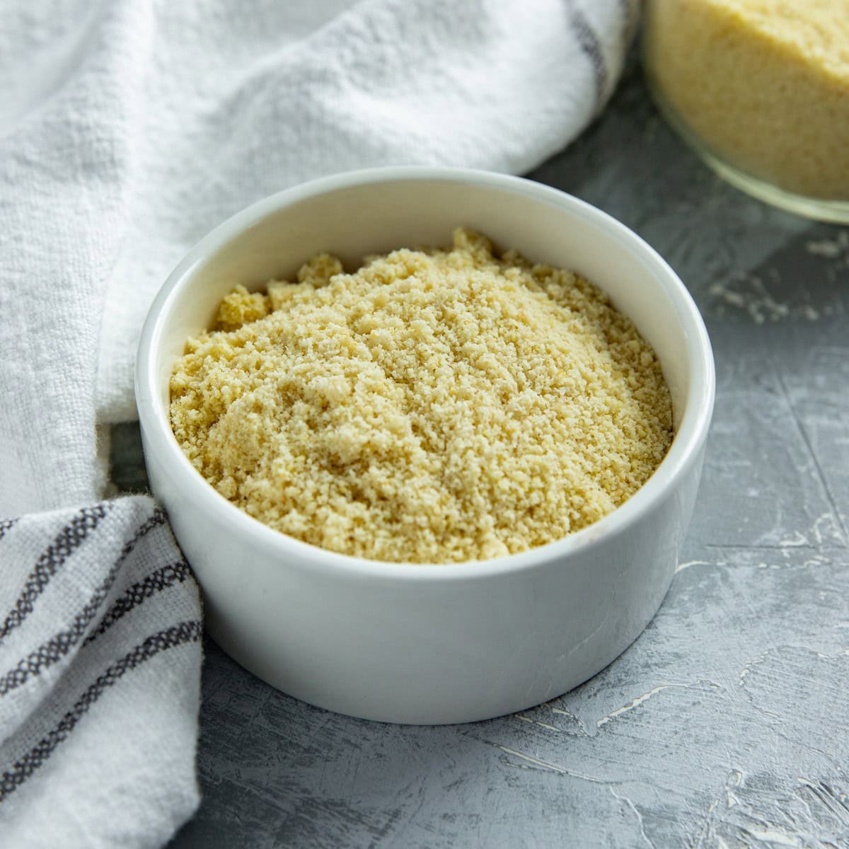 Almond flour in a small, round, white bowl.