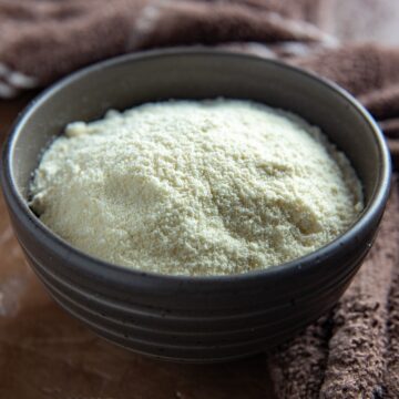 Coconut flour in a round, brown bowl.