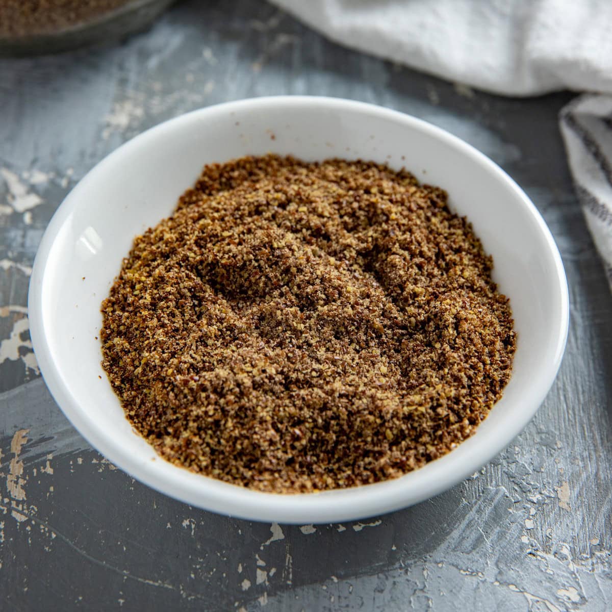 Flax meal in a white bowl.