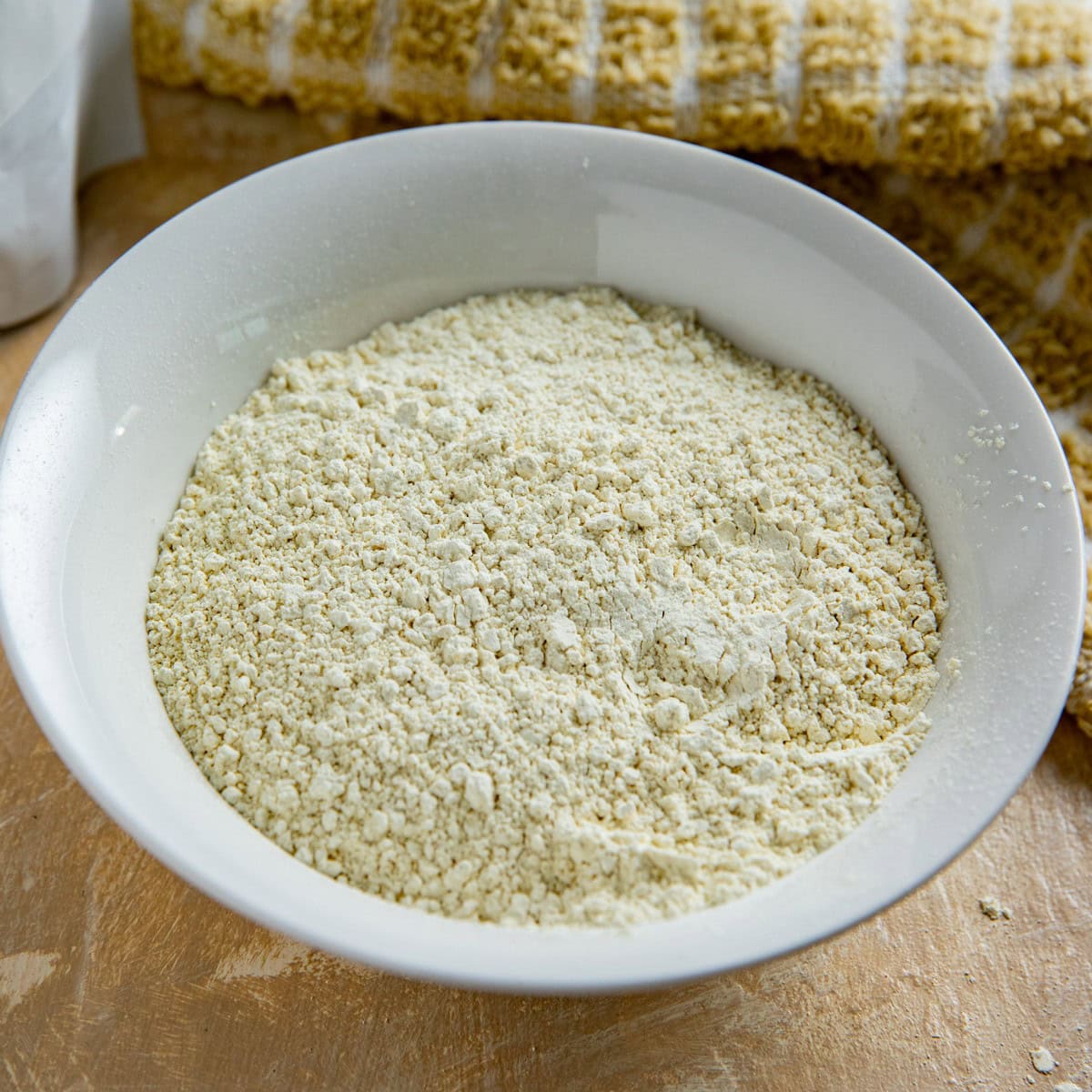 Soy flour in a white bowl.