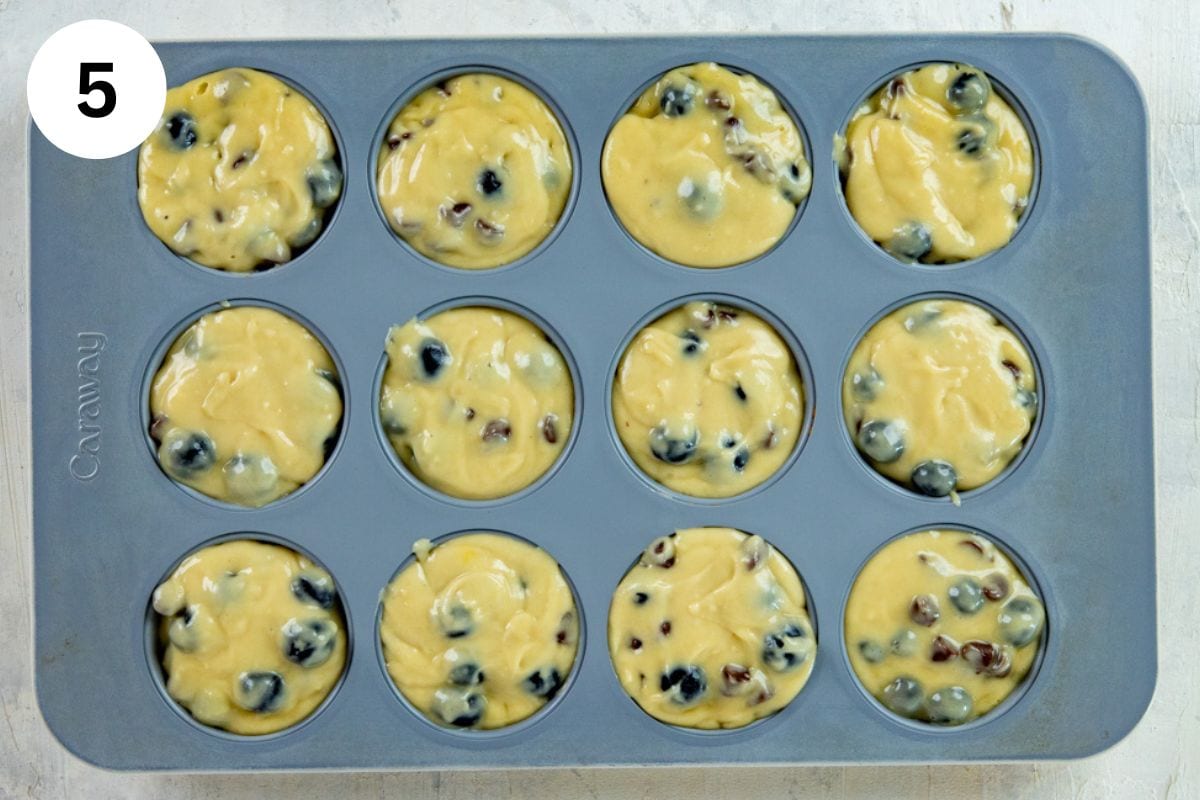 Muffin batter in muffin pan cups.