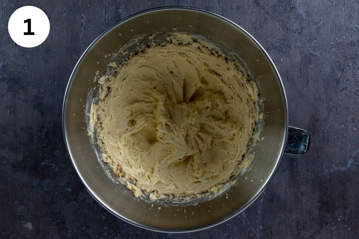 Butter, brown sugar, and white sugar blended in a stainless steel mixing bowl.