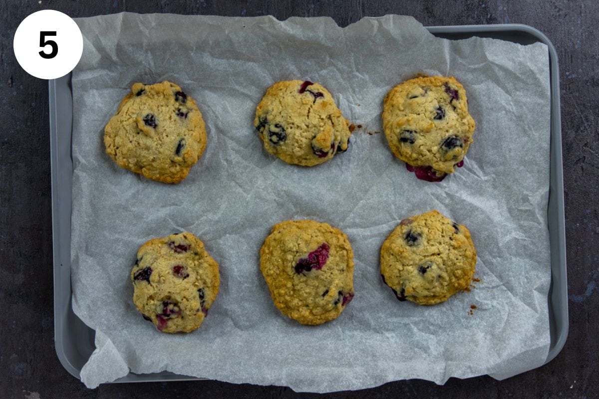 Baked cookies on parchment paper-lined cookie sheet.