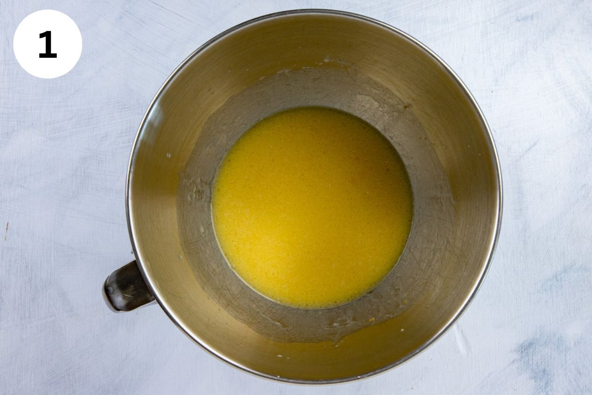 Butter, milk, orange juice, orange zest, and egg in a mixing bowl.