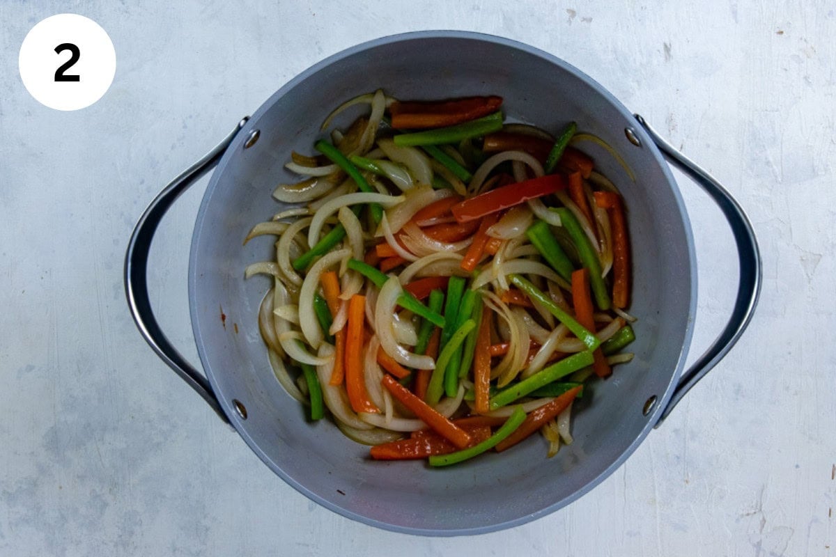 Cooked onions and bell peppers in the pot.