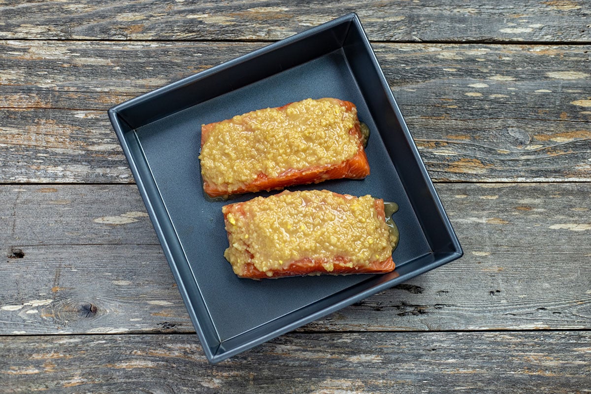 Reserved miso marinade spread on top of salmon after it's been broiled.