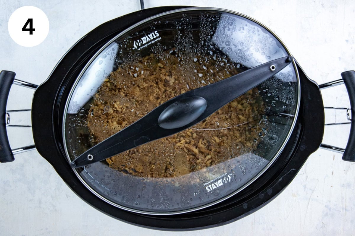 Green bean casserole cooking in the crockpot with the lid askew during the last 30 minutes so that the onions won't get soggy.