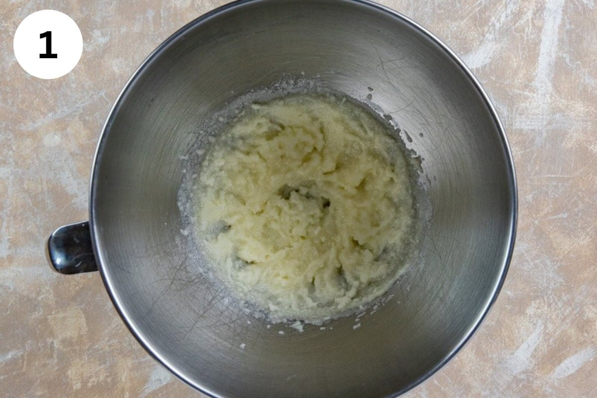 Butter and sugar blended in a bowl.