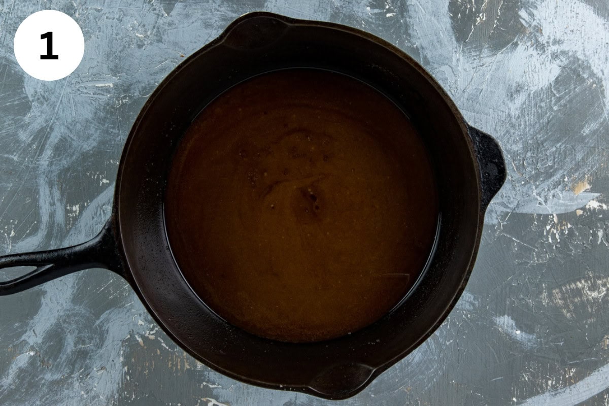 Melted butter, sugars, salt, cinnamon, and nutmeg in a cast iron skillet.