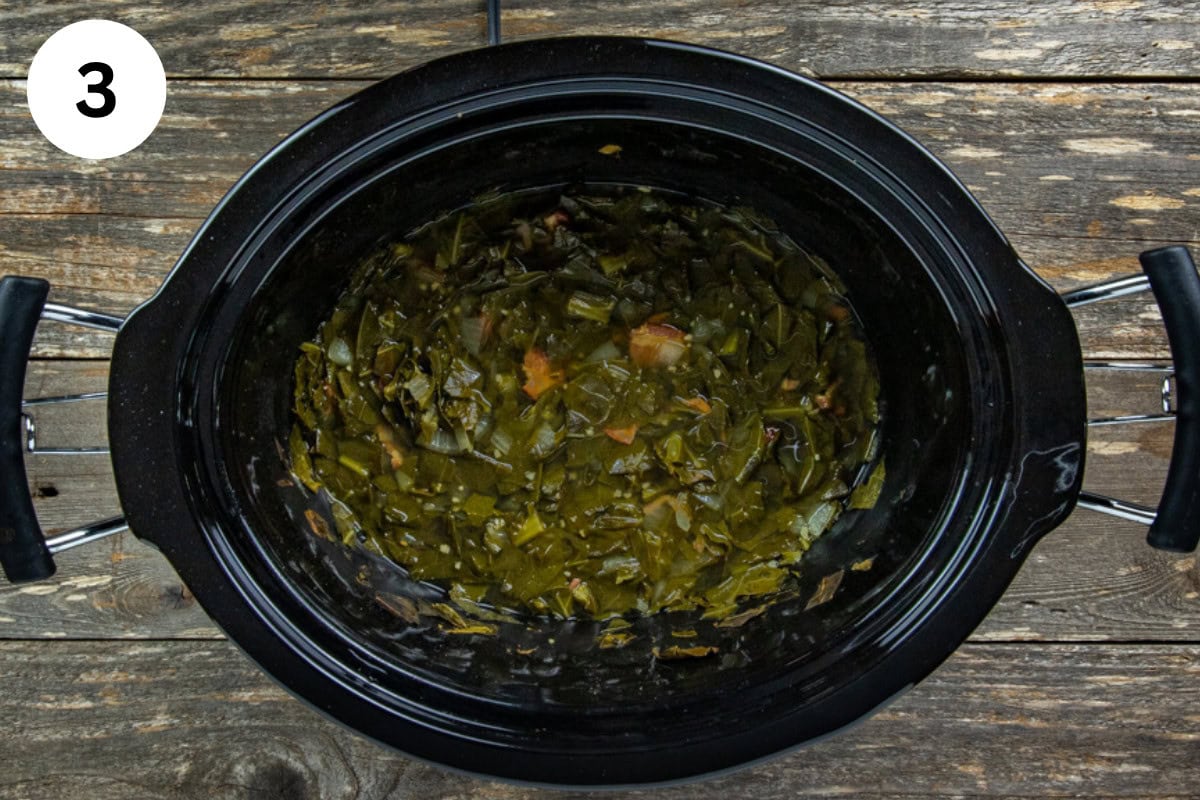 Cooked collard greens in a crockpot.