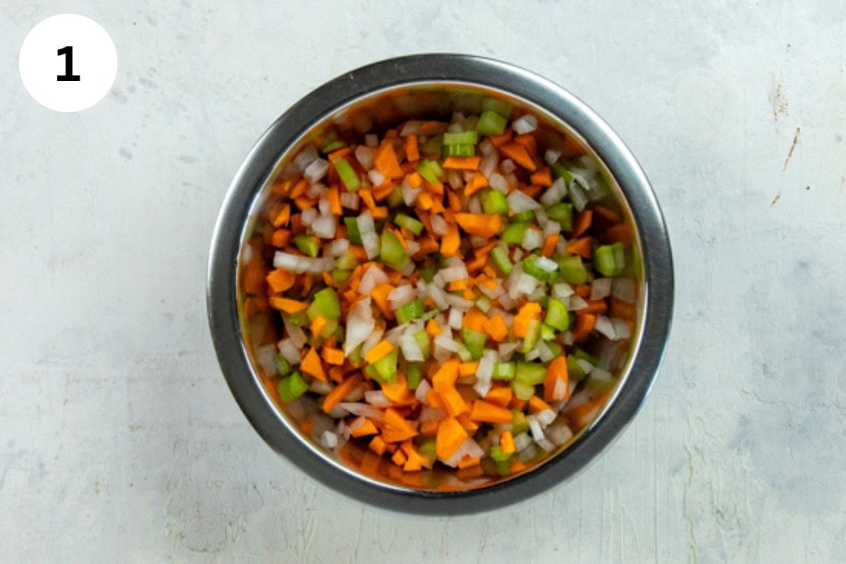 Chopped carrots, celery, and onion in a small bowl.