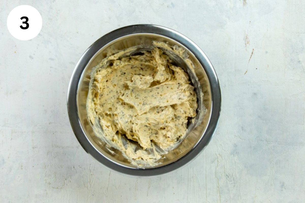 Garlic herb butter mixed up in a bowl.
