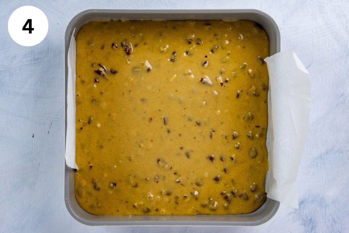 Batter added to the prepared square baking pan.