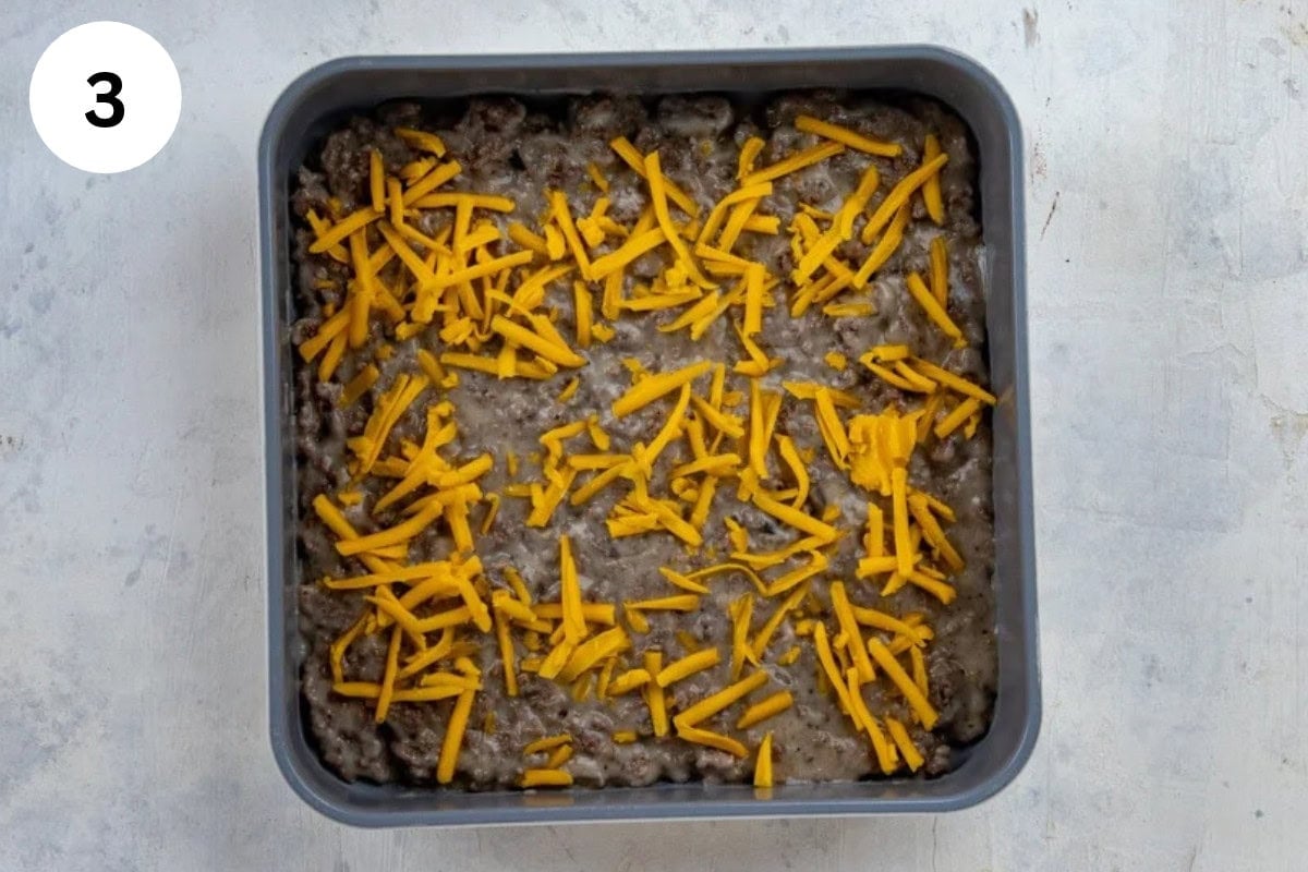 Half of the cheese sprinkled on top of the beef mixture.